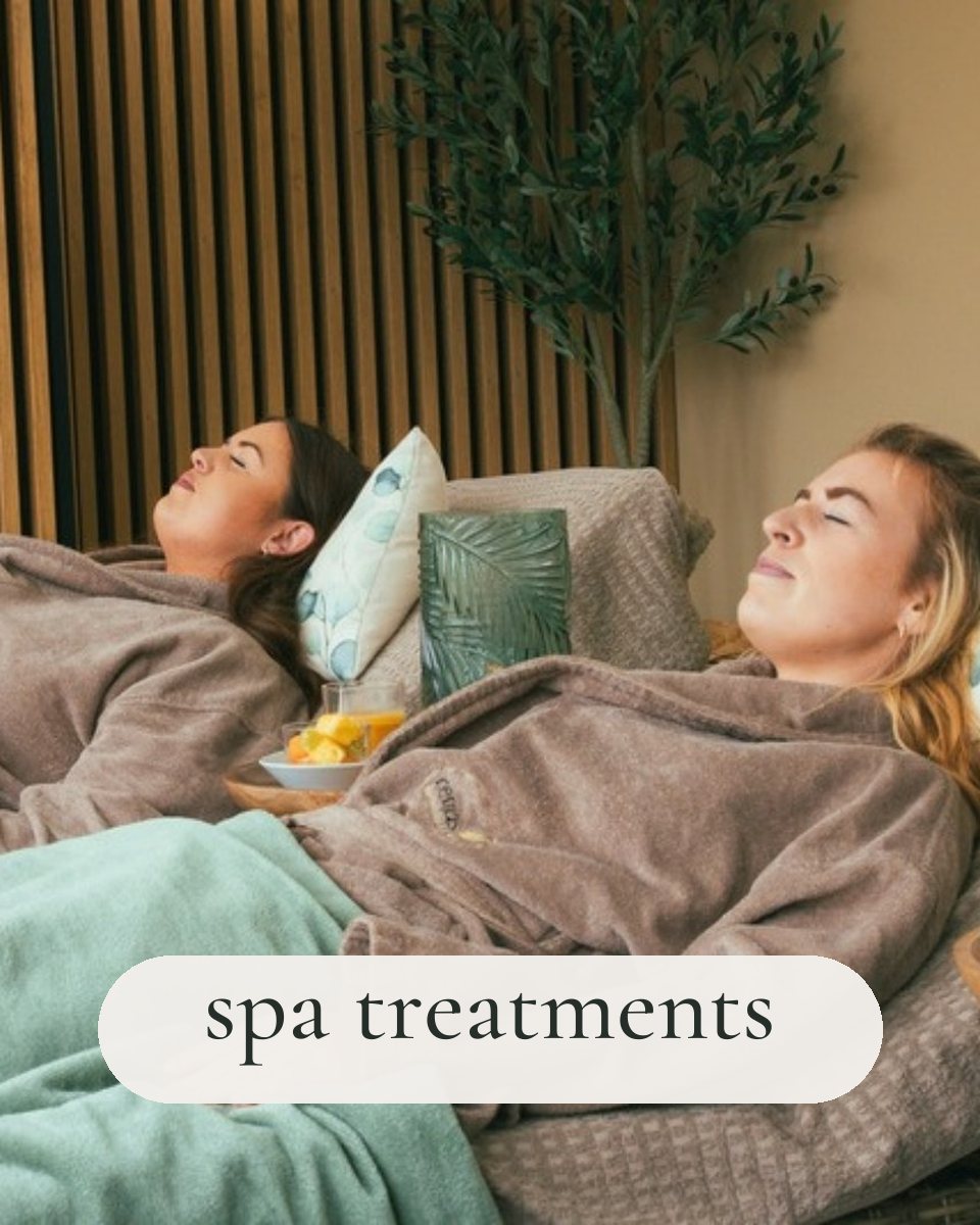 Two guests in robes relaxing on loungers at Revas Spa, with the words spa treatments